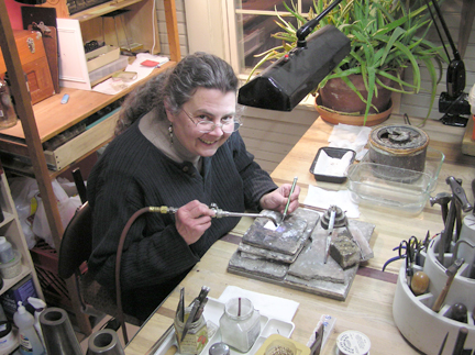 Coliene Moore is one of the artists in the building shown here in her studio.