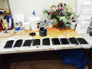 Painting each notebook with several layers of black gesso.